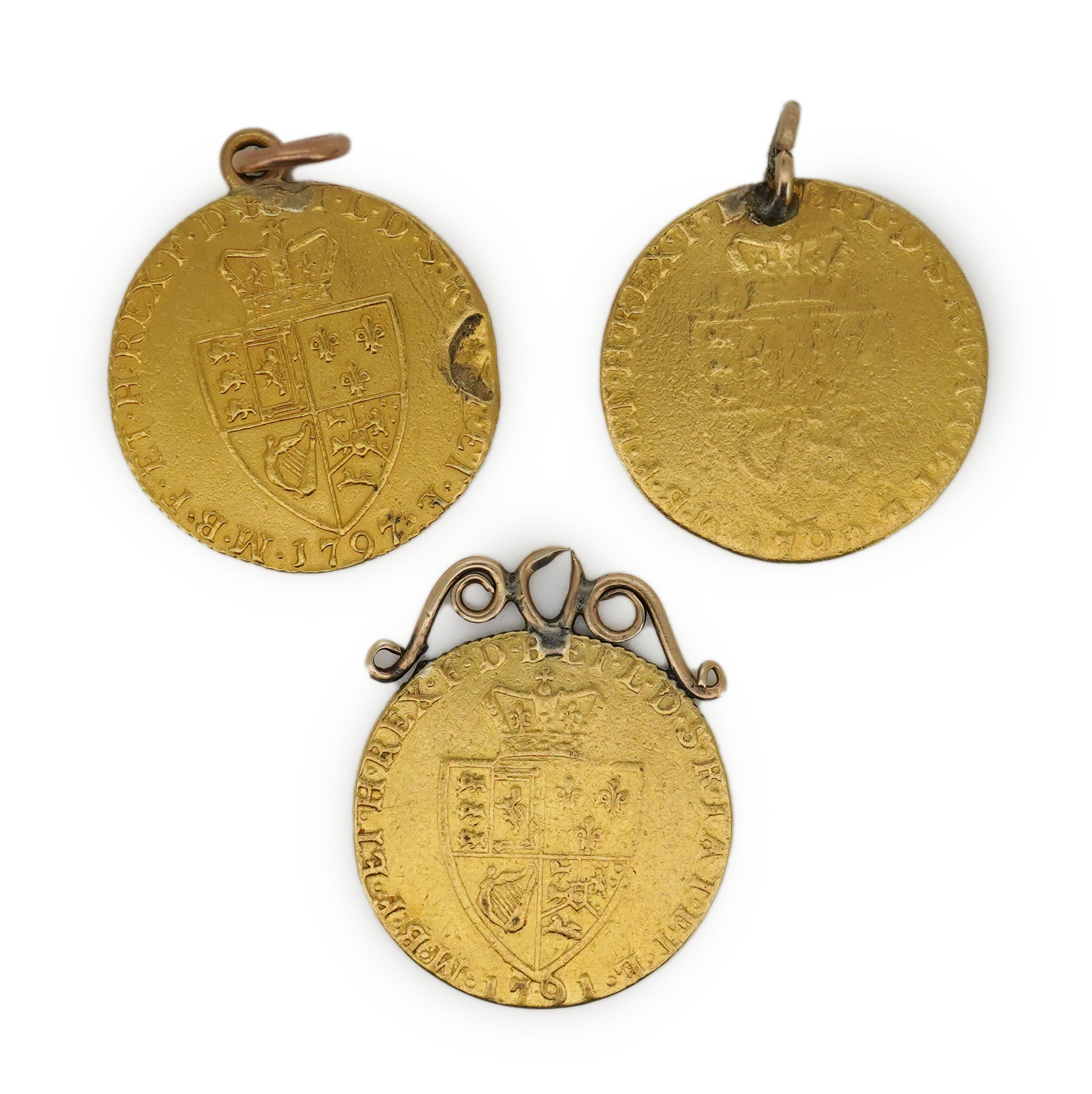 Three George III gold spade guinea coin pendants, late 18th/early 19th century and later